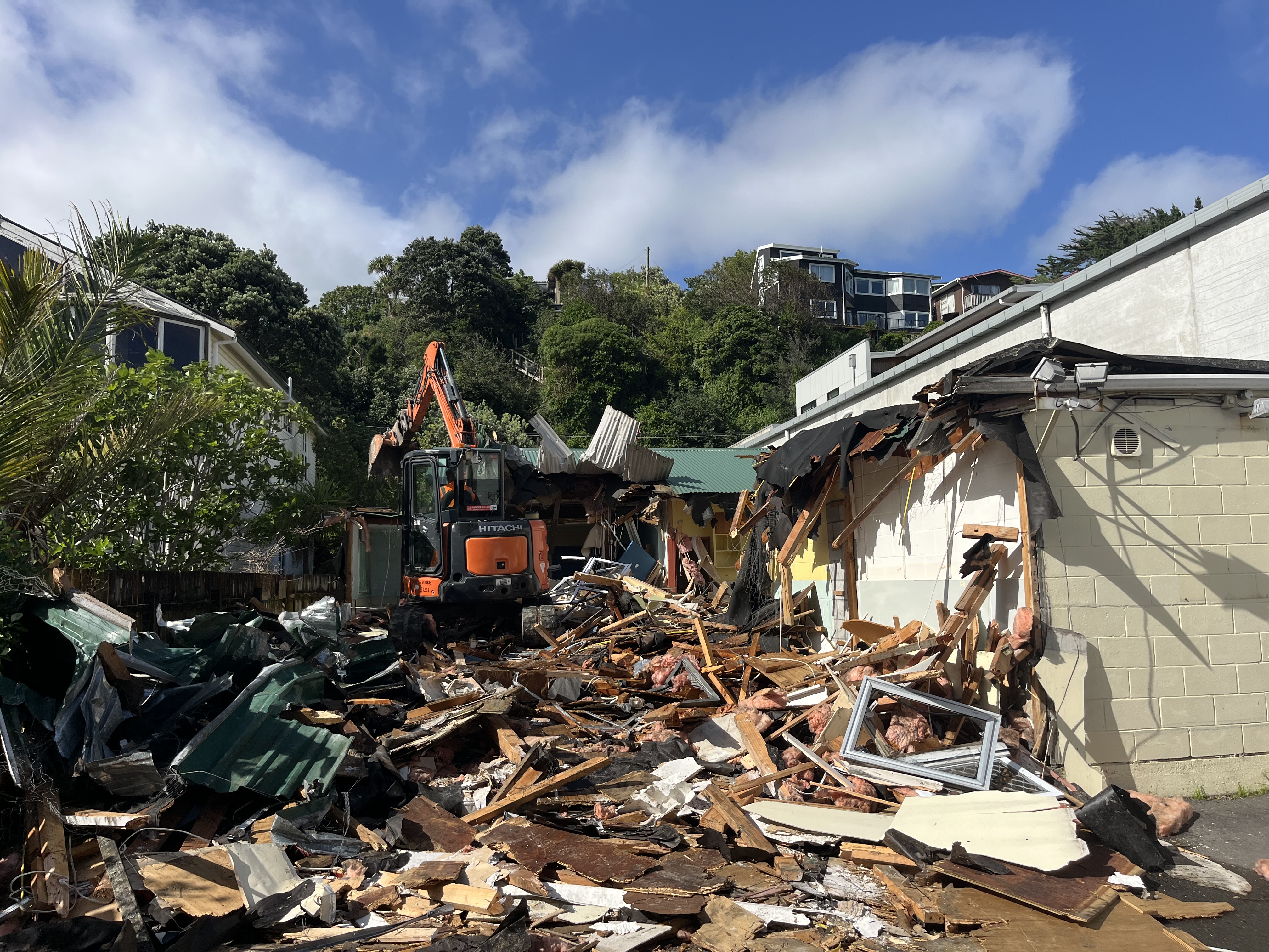 Residential demolition Wellington — EMT crew and excavator